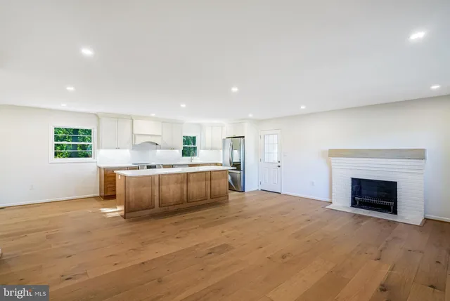 a large kitchen with a stove top oven and chandelier
