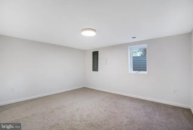 a backyard of a house with a large tree