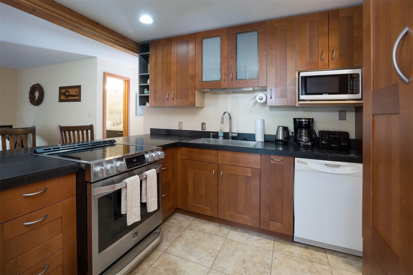 91100 Ryan Gulch Road, Unit 91105 Silverthorne, CO 80498 - Photo 10 of 49 a kitchen with stainless steel appliances granite countertop a stove a sink and a microwave