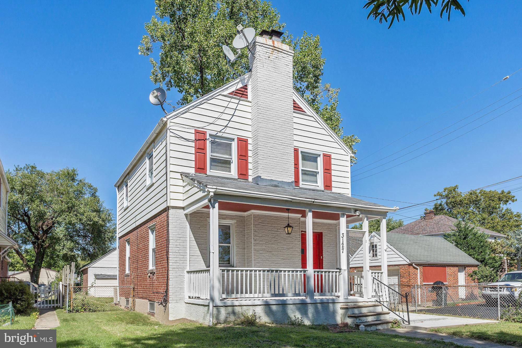 3127 Dunglow Road Baltimore, MD 21222 - Photo 1 of 14 a view of a white house with large windows and a small yard