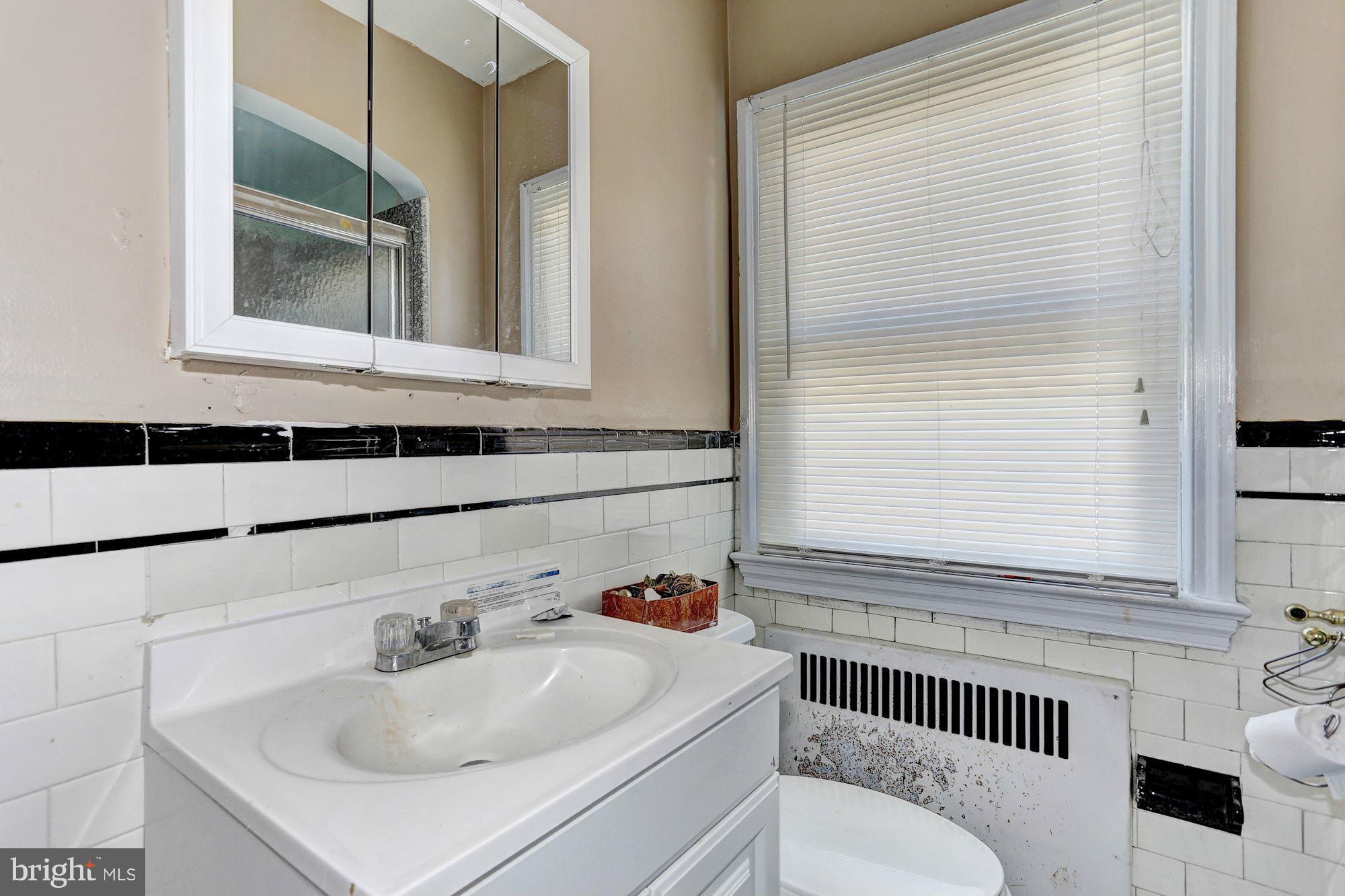 3127 Dunglow Road Baltimore, MD 21222 - Photo 12 of 14 a bathroom with a sink and a window