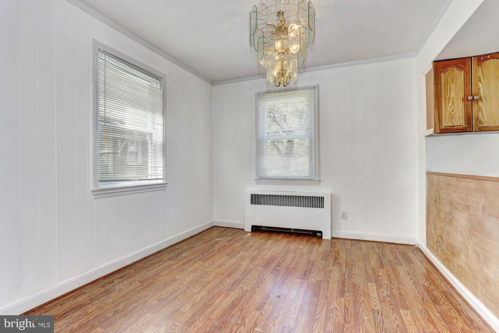 3127 Dunglow Road Baltimore, MD 21222 - Photo 4 of 14 wooden floor in an empty room with a window