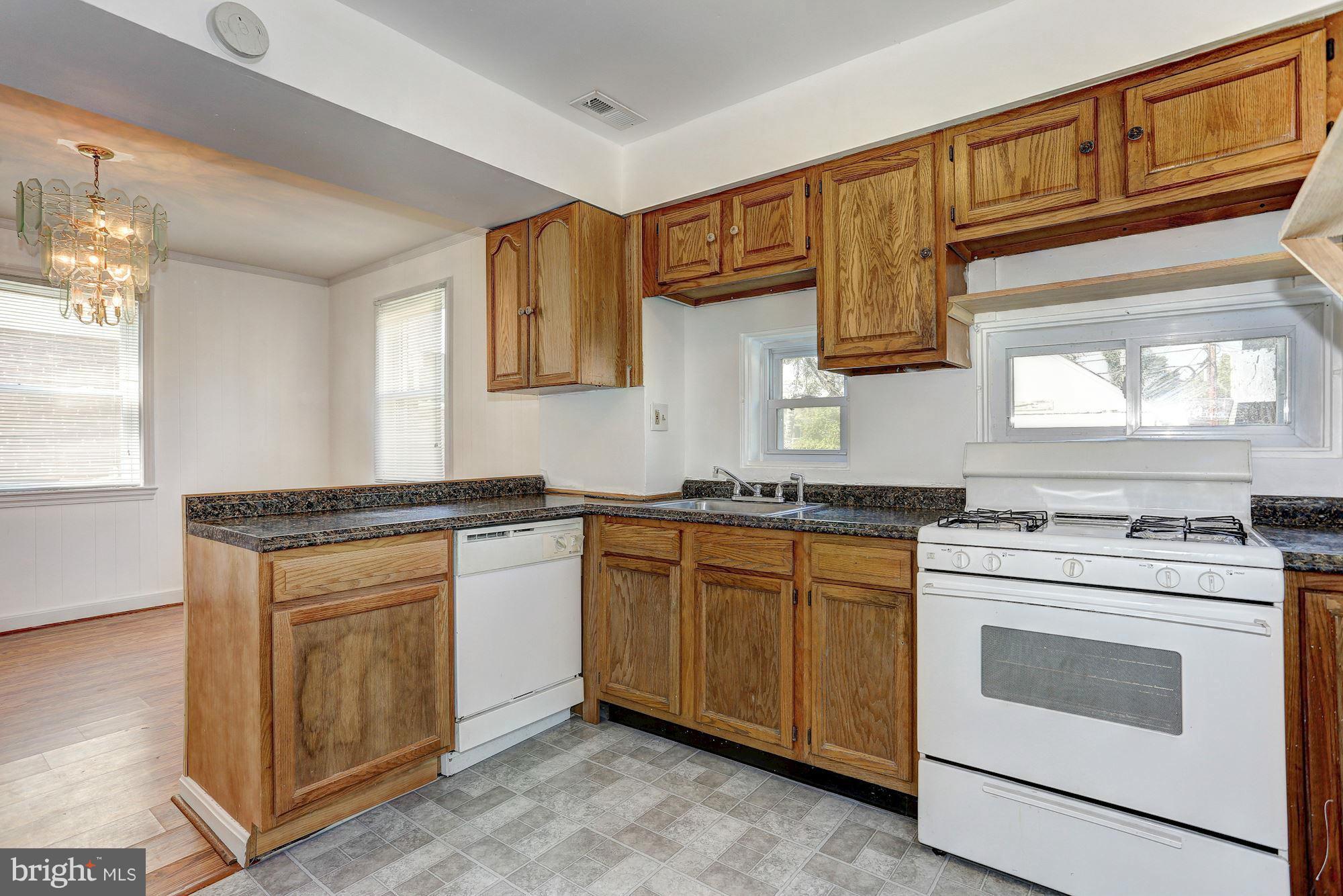 3127 Dunglow Road Baltimore, MD 21222 - Photo 6 of 14 a kitchen with granite countertop cabinets stainless steel appliances and a sink