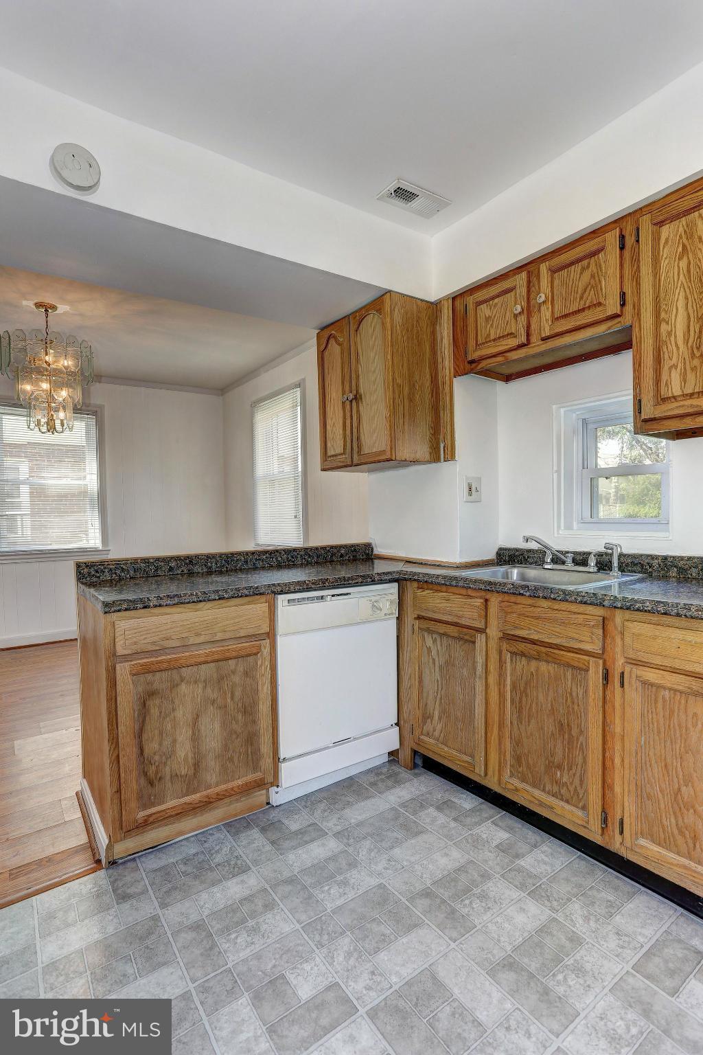 3127 Dunglow Road Baltimore, MD 21222 - Photo 7 of 14 a large kitchen with granite countertop a sink and cabinets