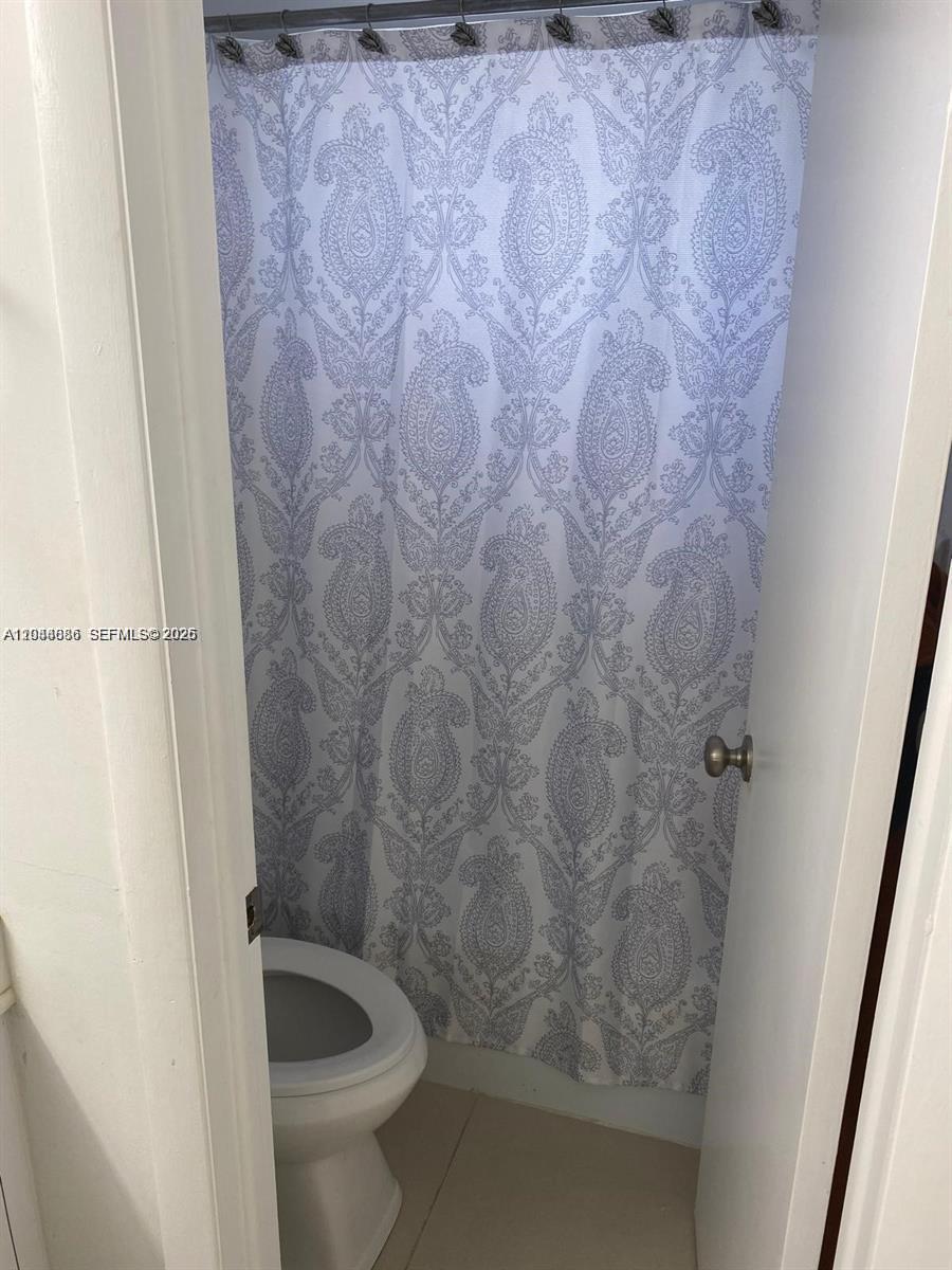8838 West McNab Road, Unit 104 Tamarac, FL 33321 - Photo 8 of 23 a bathroom with a shower and toilet