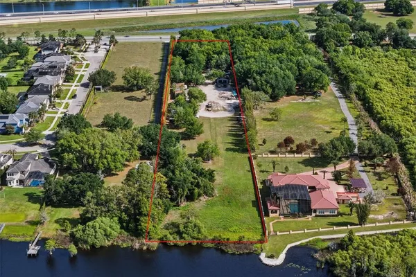 an aerial view of a house with a yard swimming pool outdoor seating and yard