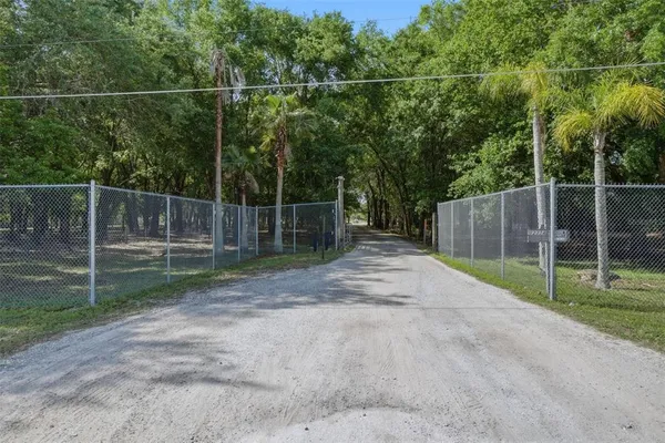 a view of a backyard with wooden fence