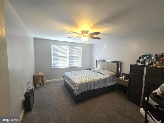 a bedroom with a bed and a chair