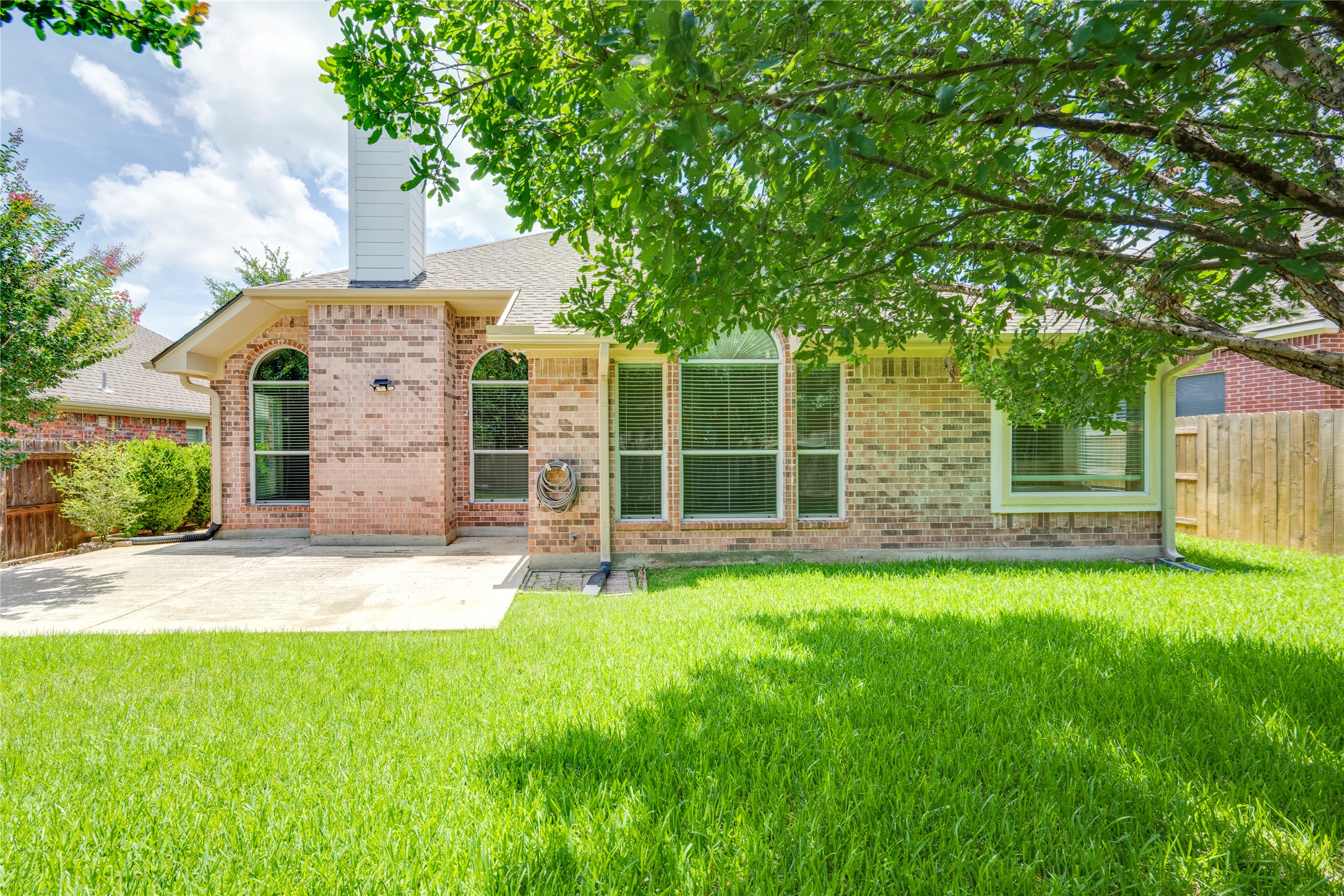 1813 Nelson Ranch Loop Cedar Park, TX 78613 - Photo 34 of 39 A well-maintained lawn and spacious patio complement this brick residence's charming exterior.