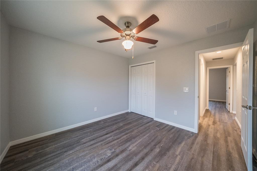 15673 Southwest 37th Circle Ocala, FL 34473 - Photo 12 of 19 a view of an empty room with wooden floor