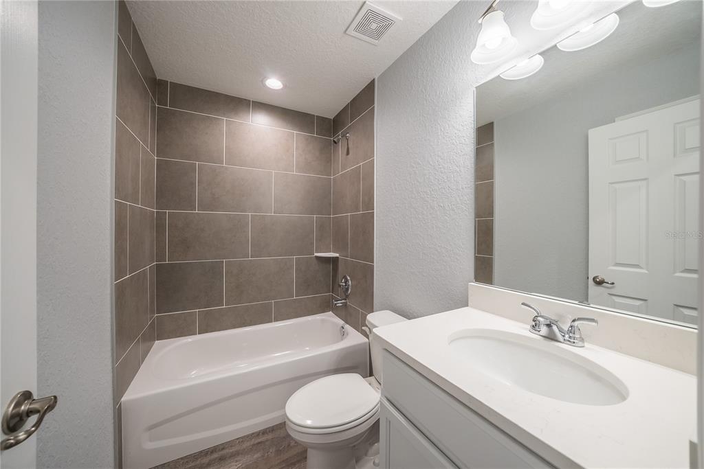 15673 Southwest 37th Circle Ocala, FL 34473 - Photo 15 of 19 a bathroom with a bathtub a sink a toilet a mirror and shower