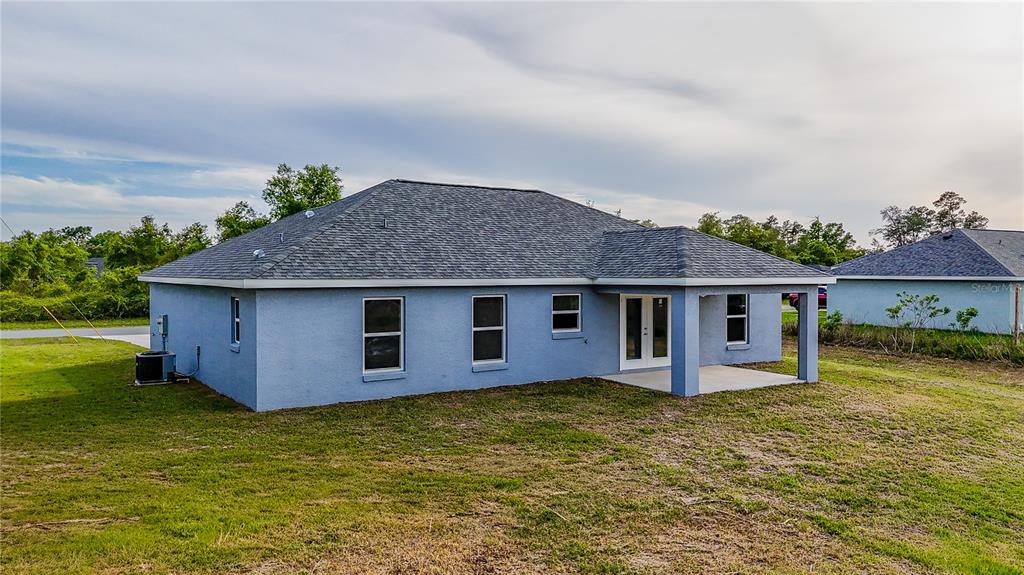 15673 Southwest 37th Circle Ocala, FL 34473 - Photo 17 of 19 a front view of a house with garden