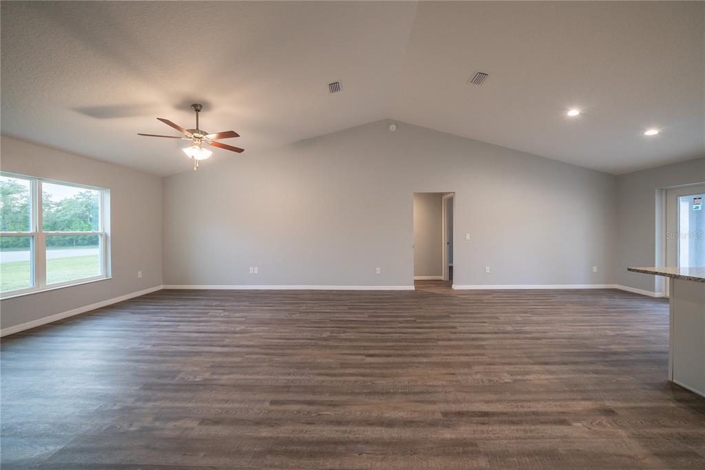15673 Southwest 37th Circle Ocala, FL 34473 - Photo 2 of 19 a view of an empty room with window and wooden floor