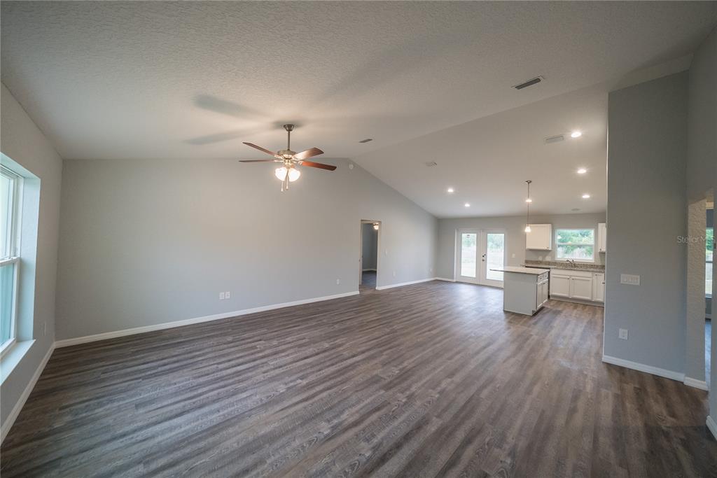 15673 Southwest 37th Circle Ocala, FL 34473 - Photo 6 of 19 a view of an empty room with wooden floor and a window