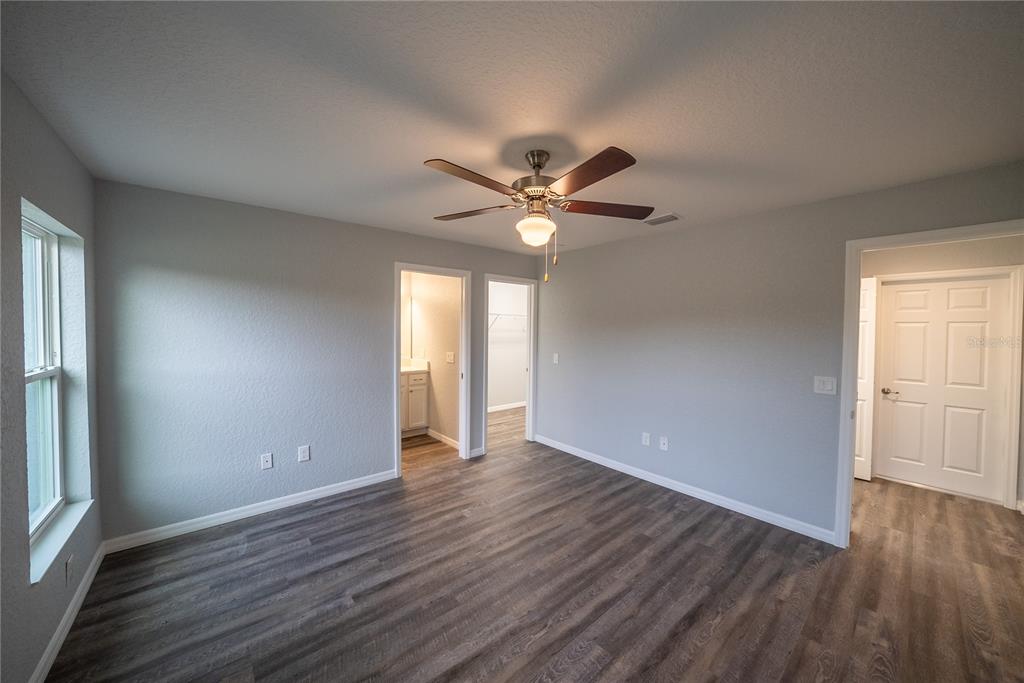 15673 Southwest 37th Circle Ocala, FL 34473 - Photo 7 of 19 a view of an empty room with wooden floor and a window