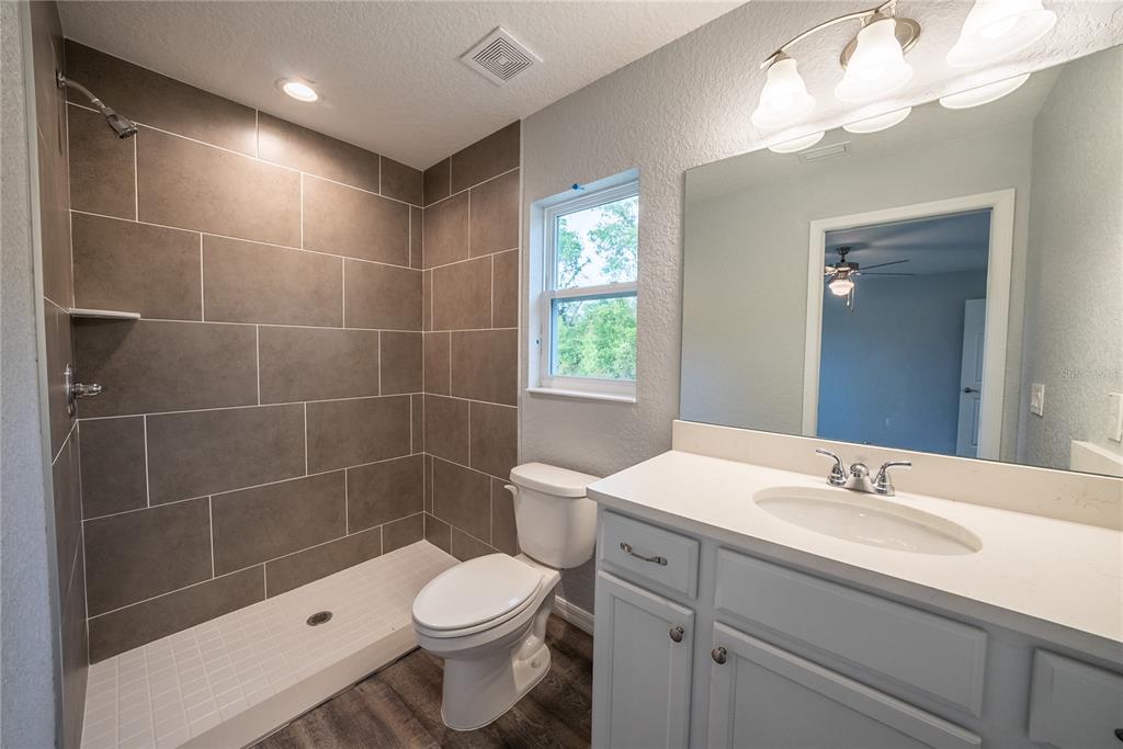 15673 Southwest 37th Circle Ocala, FL 34473 - Photo 10 of 19 a bathroom with a sink a toilet and shower