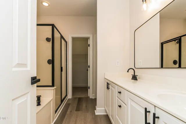 a spacious bathroom with a double vanity sink and a mirror