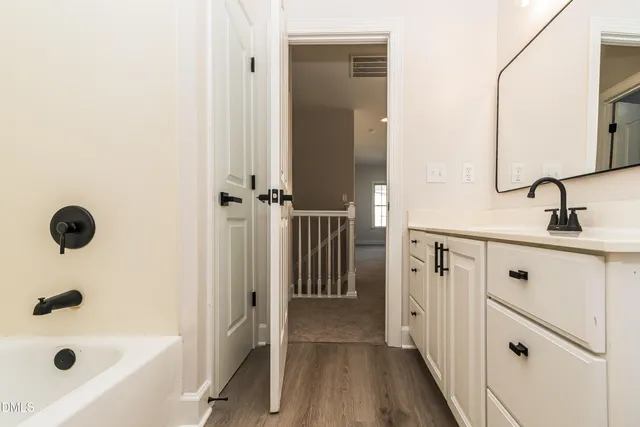 a bathroom with a tub and shower