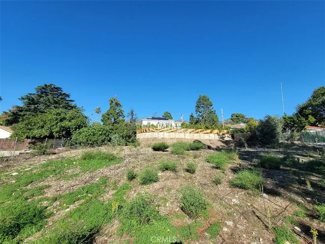 a backyard of a house with a yard and outdoor seating