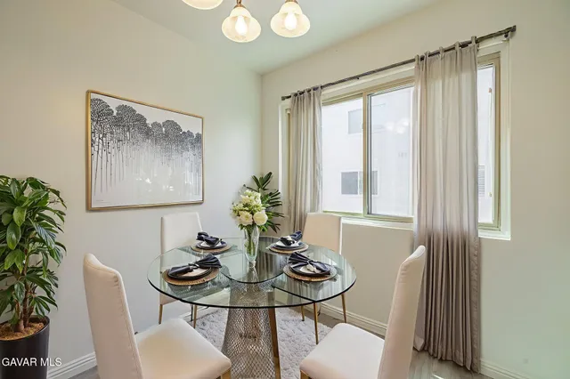 a dining room with furniture and window