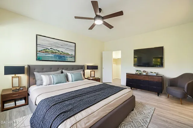 a bedroom with a bed and a flat screen tv