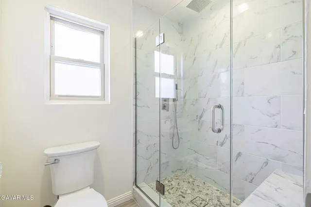 a bathroom with a shower and toilet