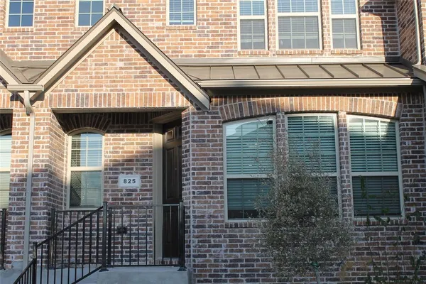 a view of a brick house with windows