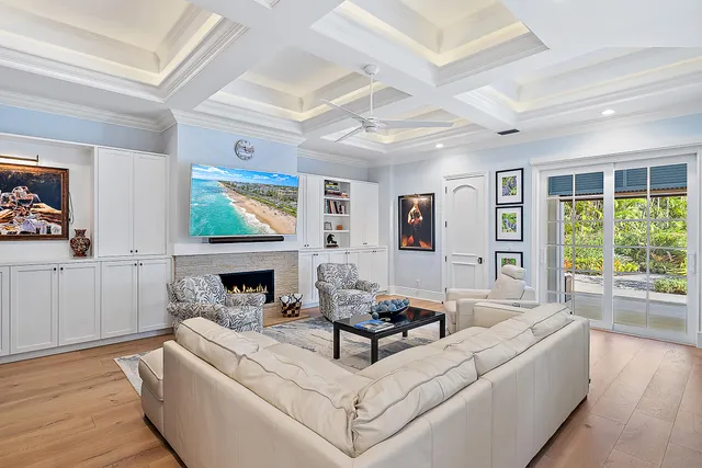 a living room with furniture a rug and a large window