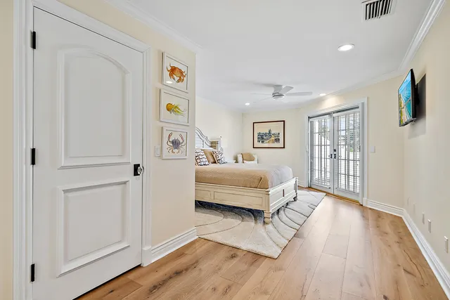 a bedroom with bed and wooden floor