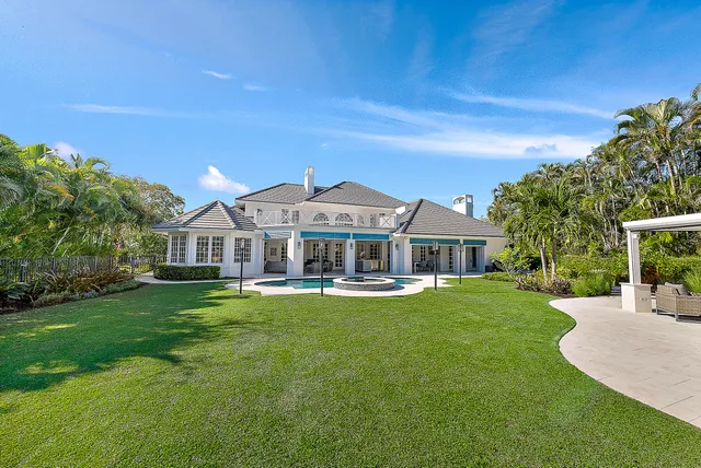 a bedroom with a large bed and a large window