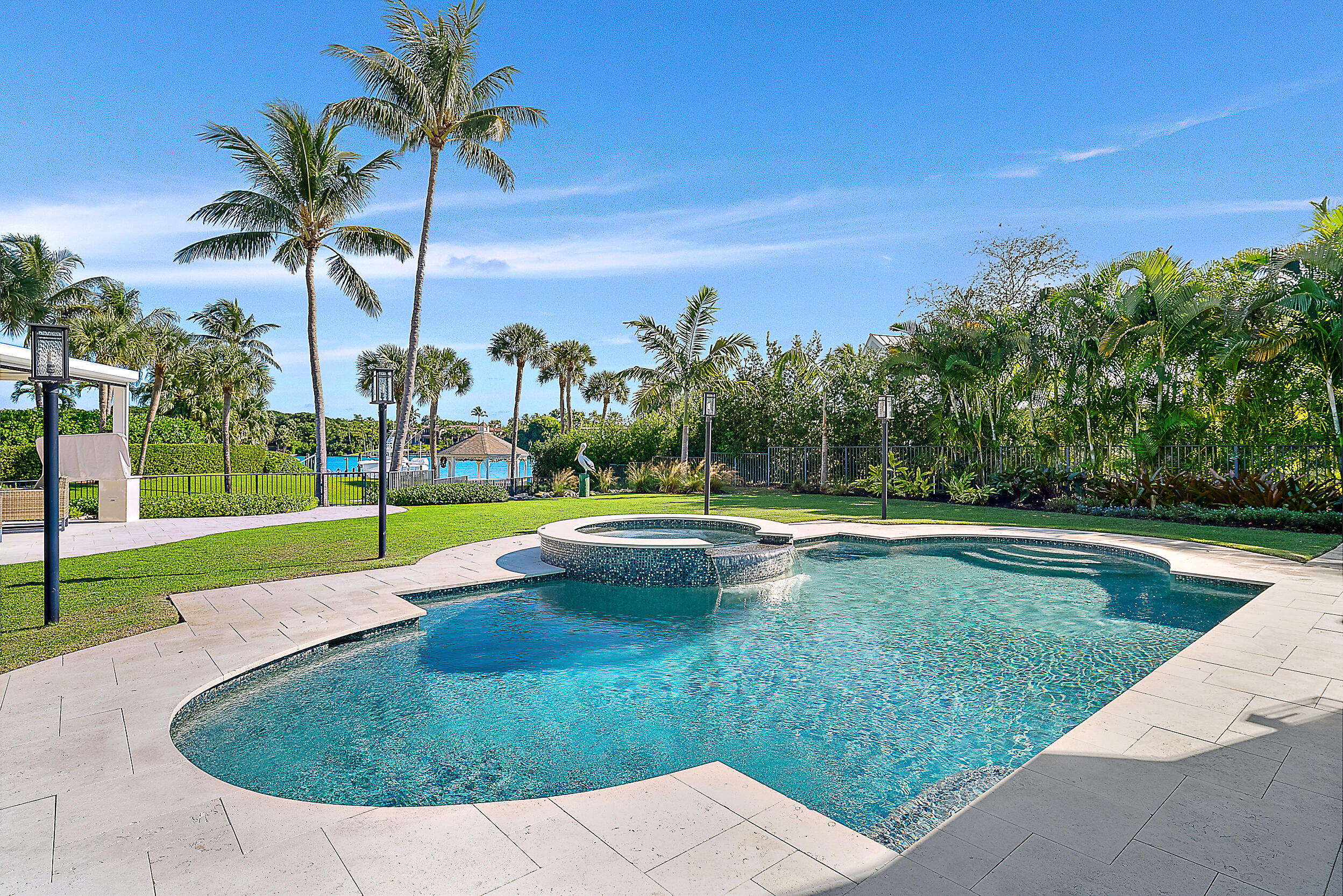 11971 Southeast Tiffany Way Jupiter, FL 33469 - Photo 37 of 53 a view of a swimming pool with a yard and palm trees