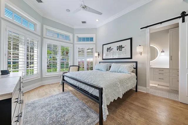 a kitchen with white cabinets and window