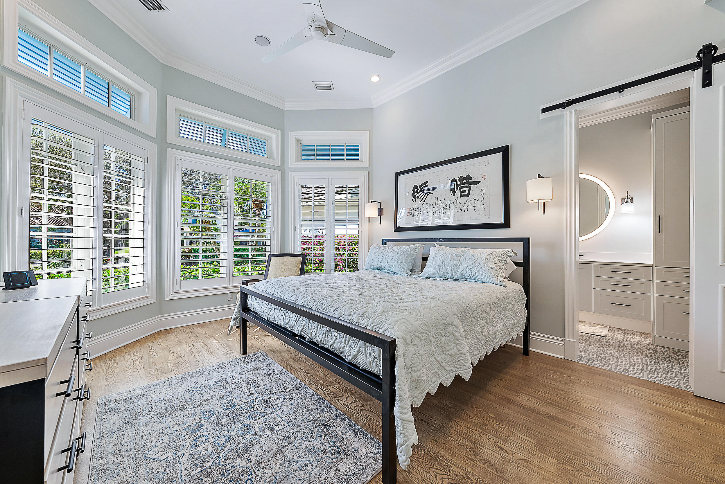 11971 Southeast Tiffany Way Jupiter, FL 33469 - Photo 38 of 53 a bedroom with a large bed and a large window