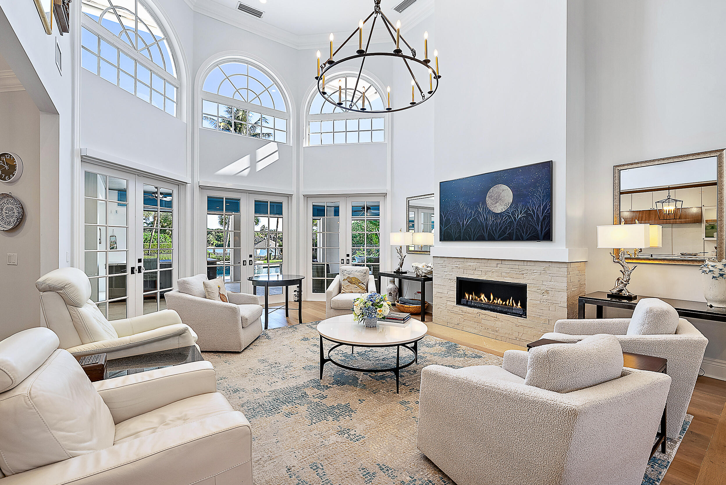 11971 Southeast Tiffany Way Jupiter, FL 33469 - Photo 4 of 53 a living room with furniture a fireplace and a chandelier
