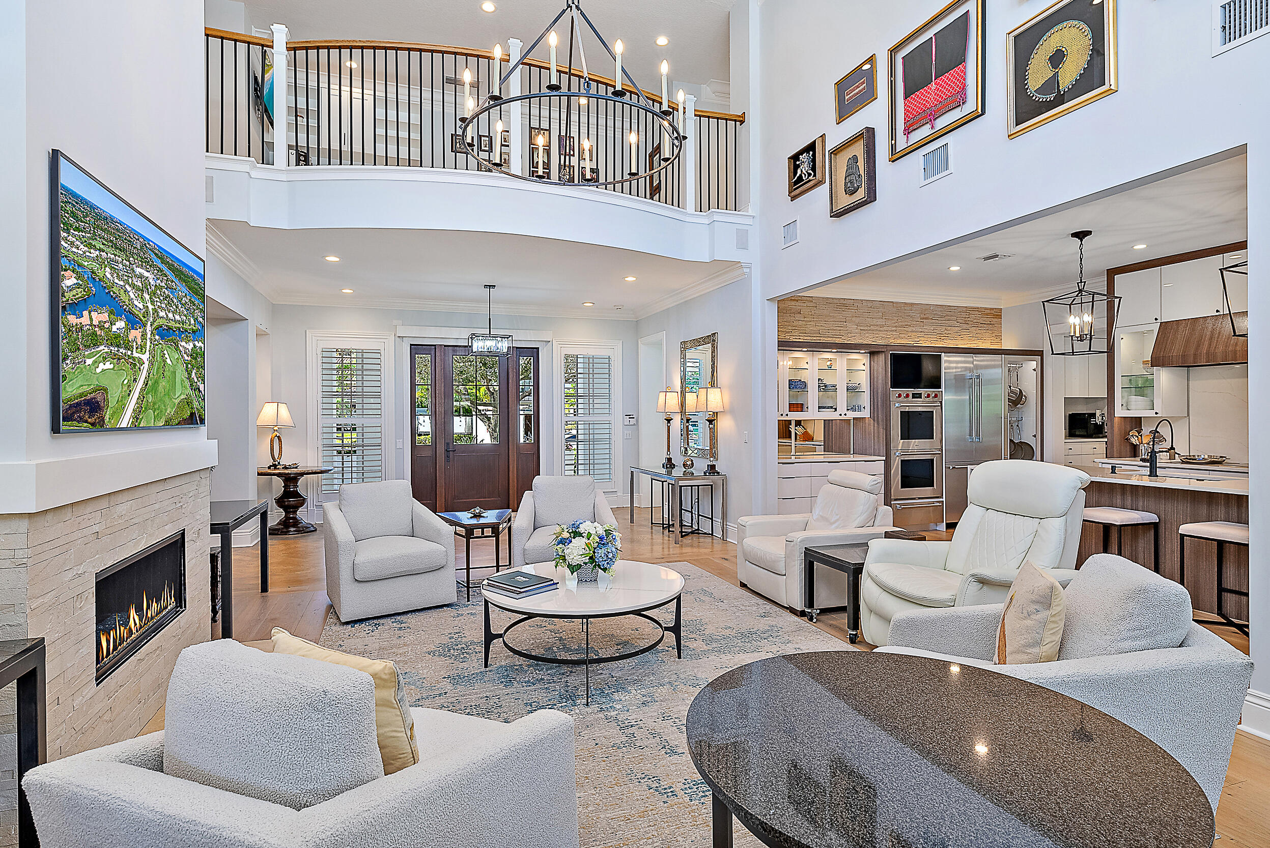 11971 Southeast Tiffany Way Jupiter, FL 33469 - Photo 7 of 53 a living room with furniture a fireplace and a chandelier