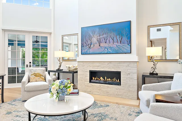 a living room with furniture and a chandelier