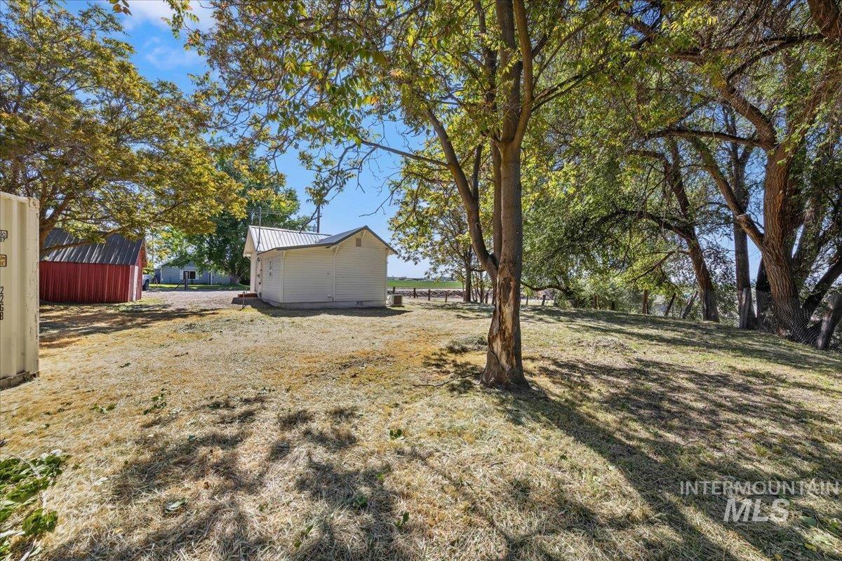 109 Parma Road Parma, ID 83660 - Photo 27 of 31 Expansive outdoor space featuring mature trees providing ample shade, and a red barn-style structure