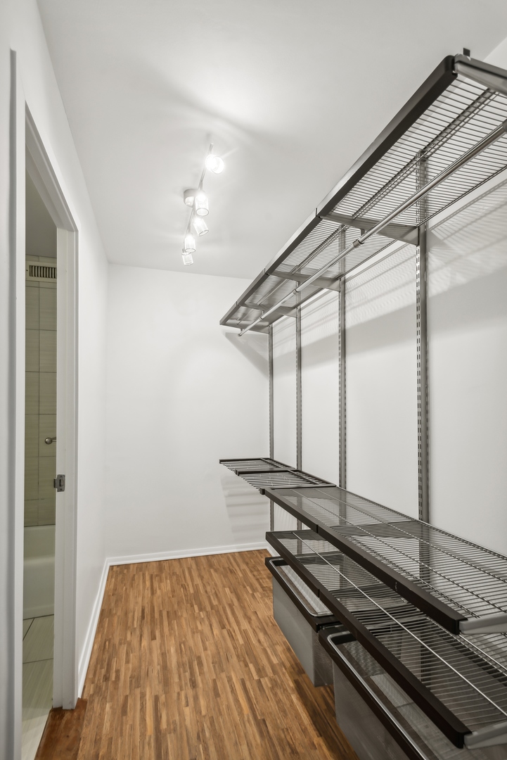 21 West Goethe Street, Unit 17K Chicago, IL 60610 - Photo 12 of 16 a room with wooden floor and windows