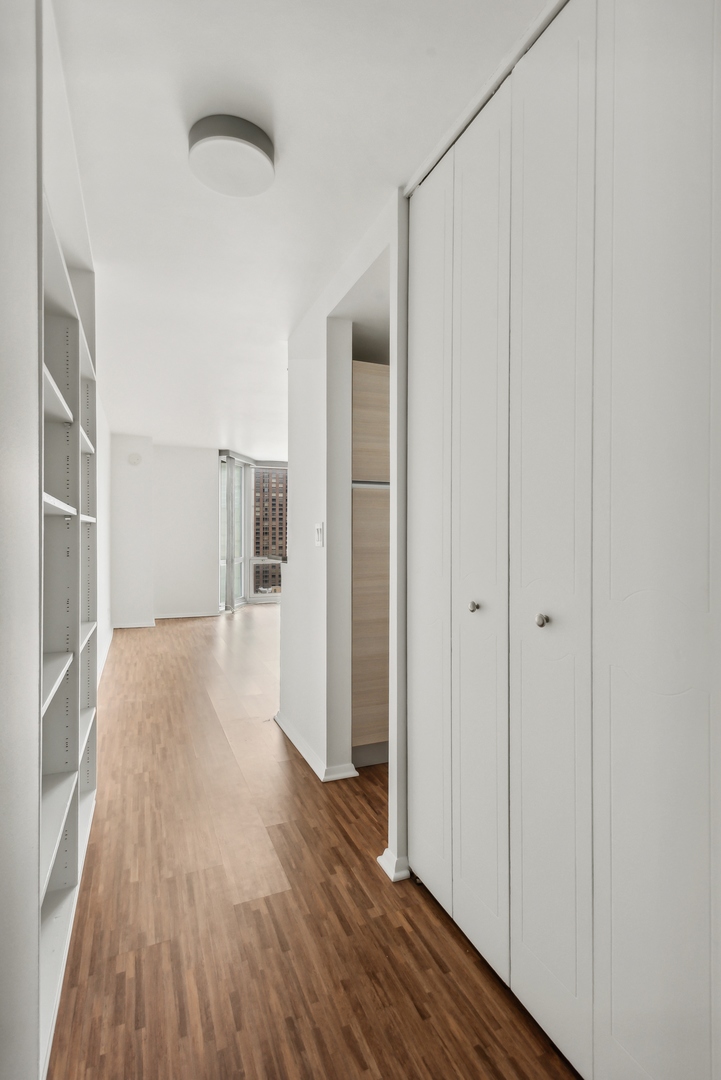 21 West Goethe Street, Unit 17K Chicago, IL 60610 - Photo 2 of 16 a view of hallway with wooden floor