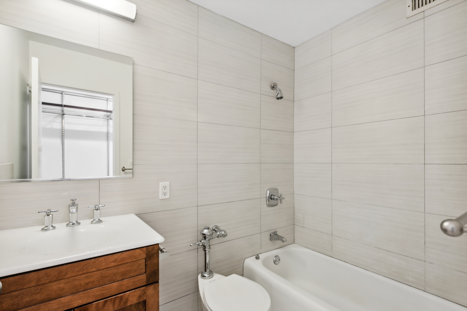 21 West Goethe Street, Unit 17K Chicago, IL 60610 - Photo 9 of 16 a bathroom with a sink mirror toilet and bathtub