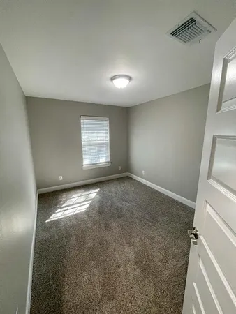 an empty room with a empty space and windows