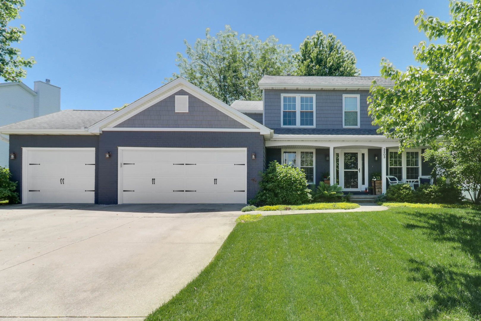3203 Eagle Crest Road Bloomington, IL 61704 - Photo 1 of 52 a front view of a house with a yard and garage