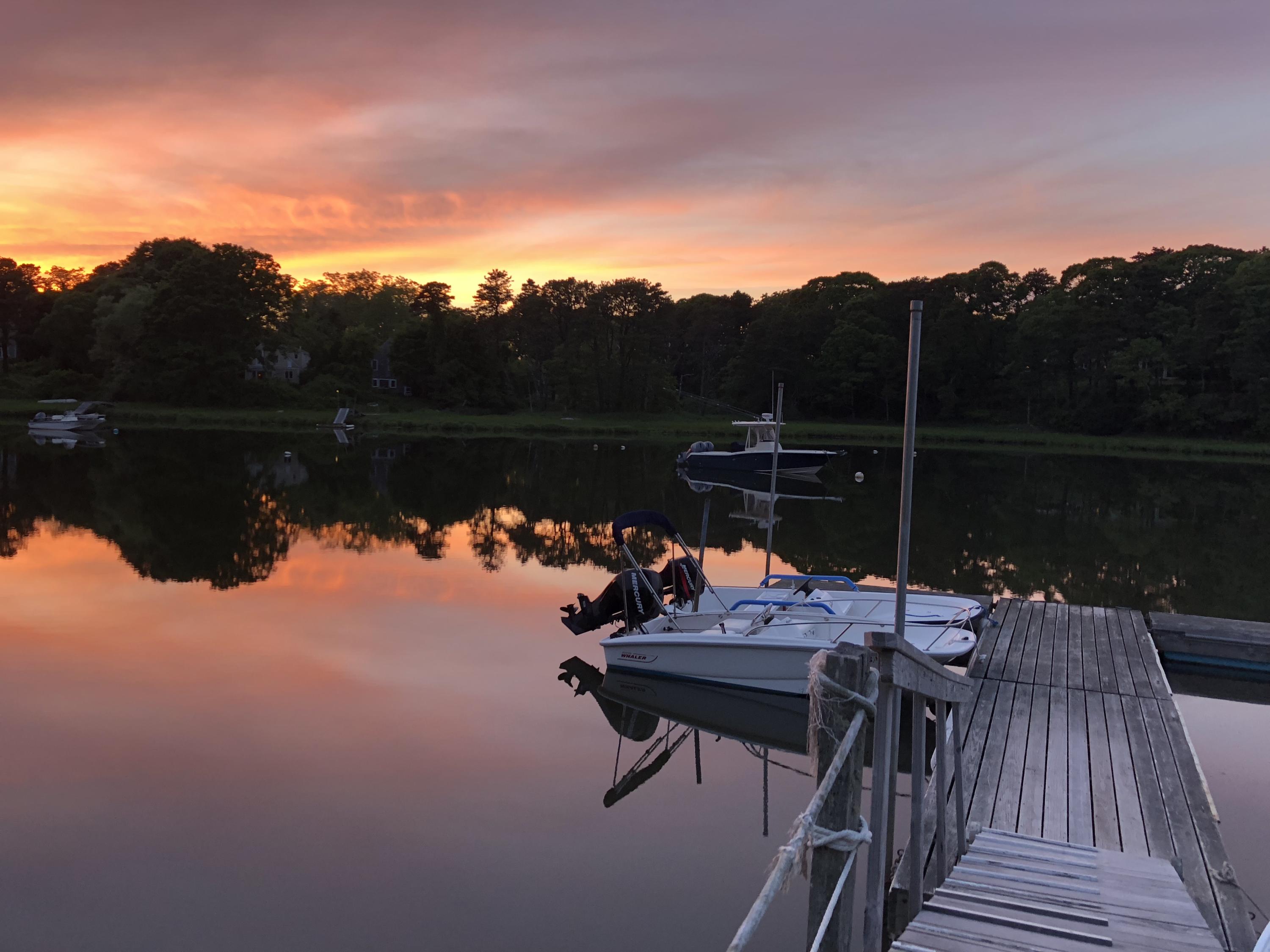 3 Riverview Drive Orleans, MA 02653 - Photo 11 of 63 a view of a lake with couches chairs and wooden floor
