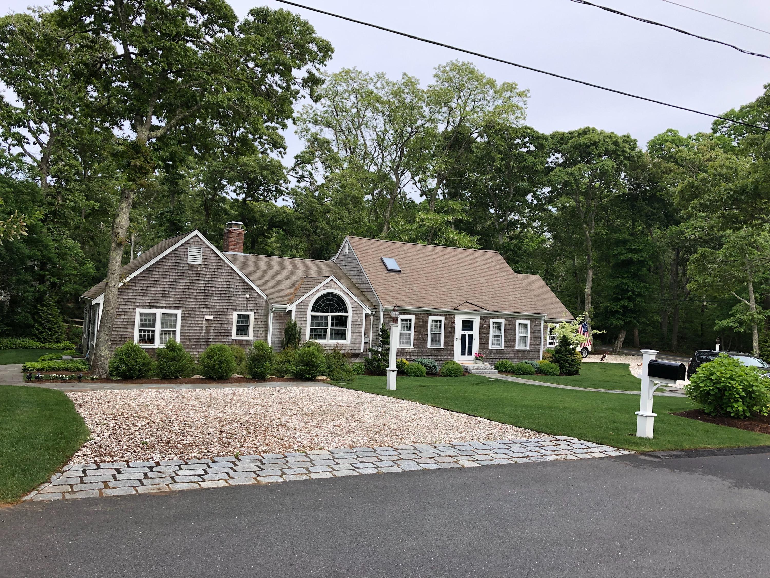 3 Riverview Drive Orleans, MA 02653 - Photo 4 of 63 a front view of a house with a yard and trees