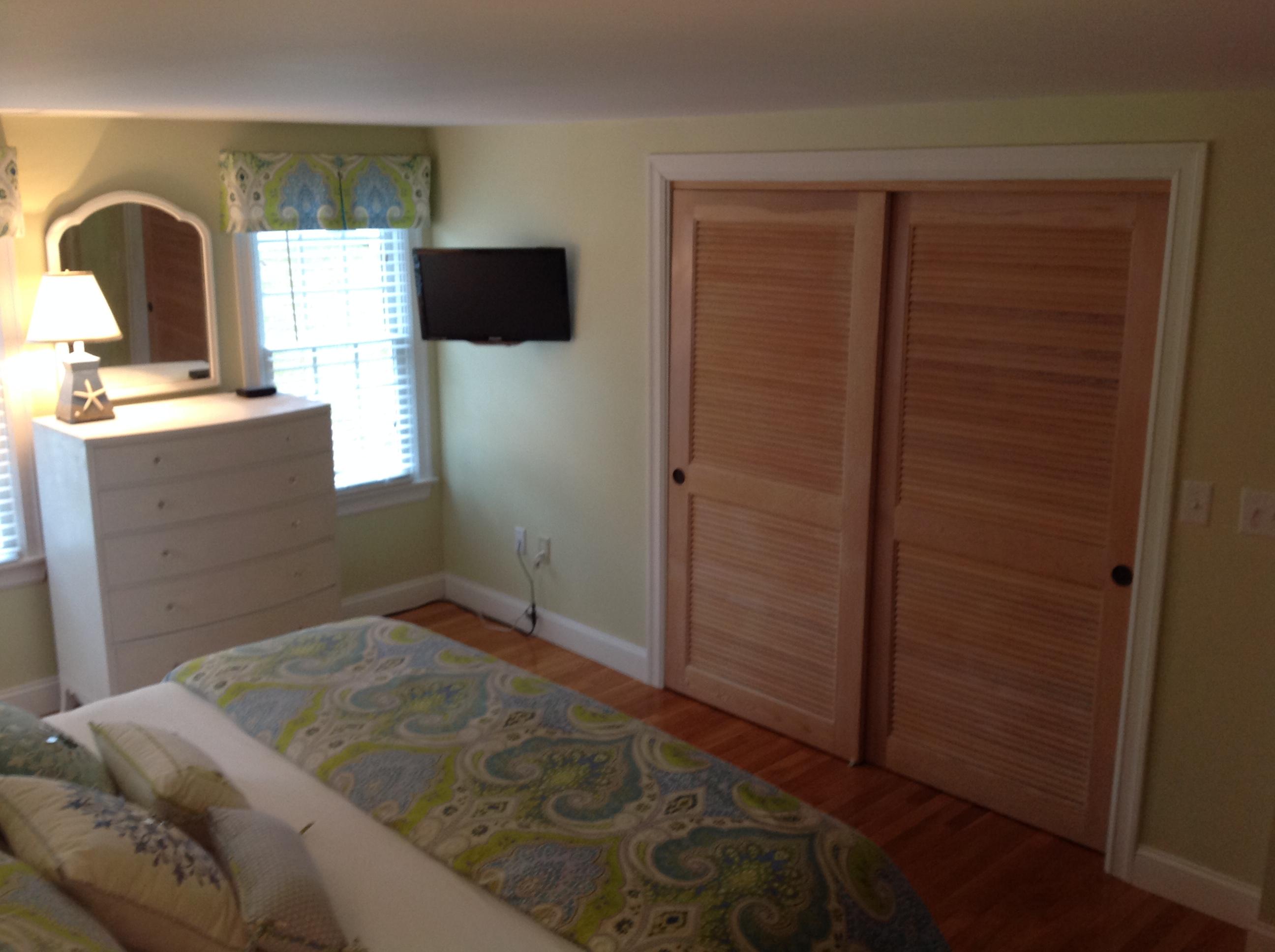 3 Riverview Drive Orleans, MA 02653 - Photo 44 of 63 a bedroom with a bed and a flat tv screen on dresser