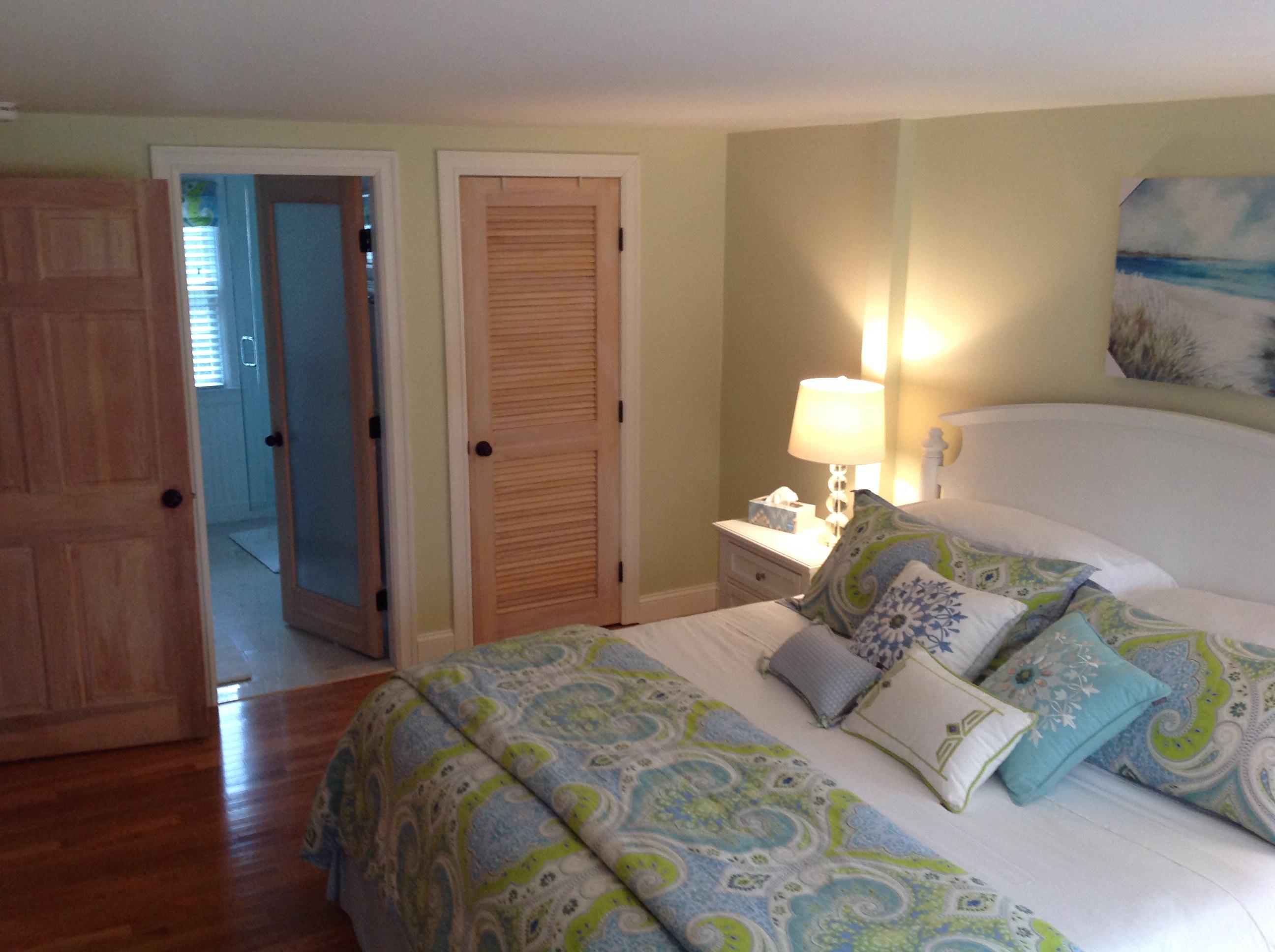 3 Riverview Drive Orleans, MA 02653 - Photo 45 of 63 a bedroom with a bed and a lamp