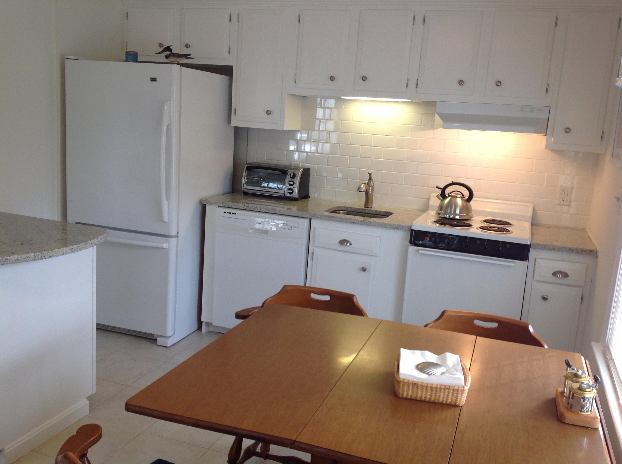 3 Riverview Drive Orleans, MA 02653 - Photo 59 of 63 a kitchen with stainless steel appliances a refrigerator sink and cabinets