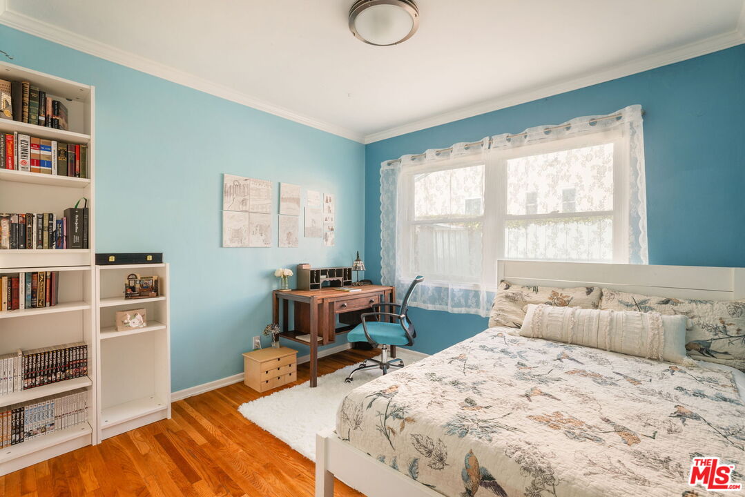 3024 Highview Avenue Altadena, CA 91001 - Photo 11 of 25 a bed sitting in a bedroom next to a window with a bookshelf