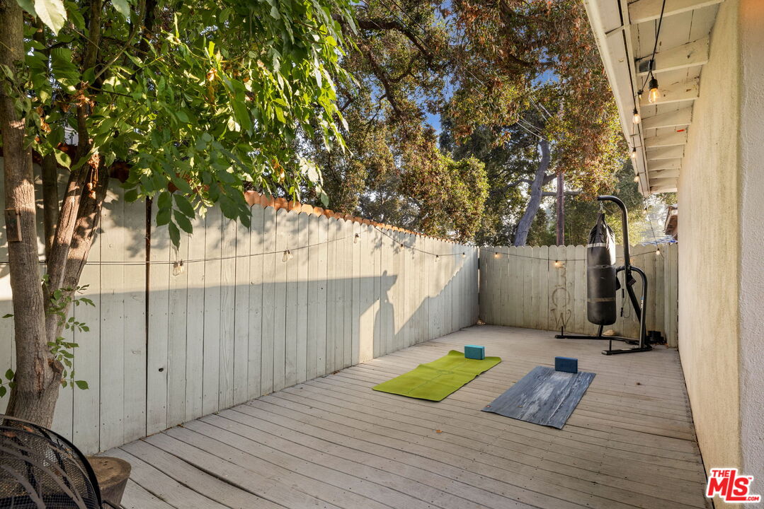 3024 Highview Avenue Altadena, CA 91001 - Photo 22 of 25 a view of a backyard with a wooden fence and a large tree