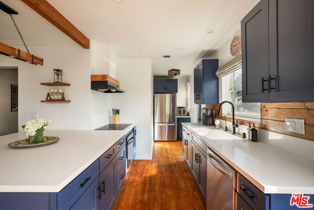 3024 Highview Avenue Altadena, CA 91001 - Photo 9 of 25 a kitchen with kitchen island granite countertop a sink a counter space appliances and cabinets